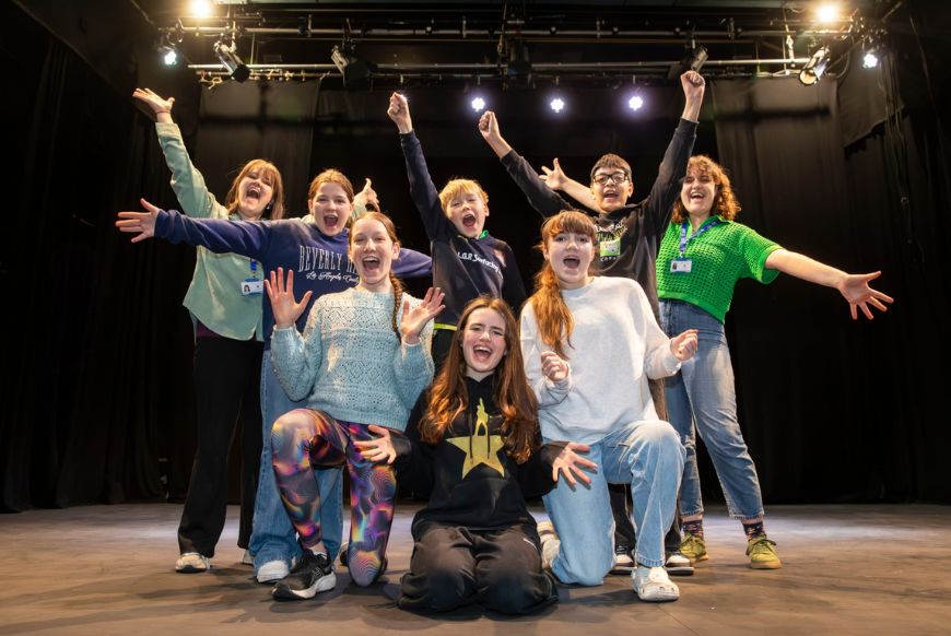 children on a stage singing